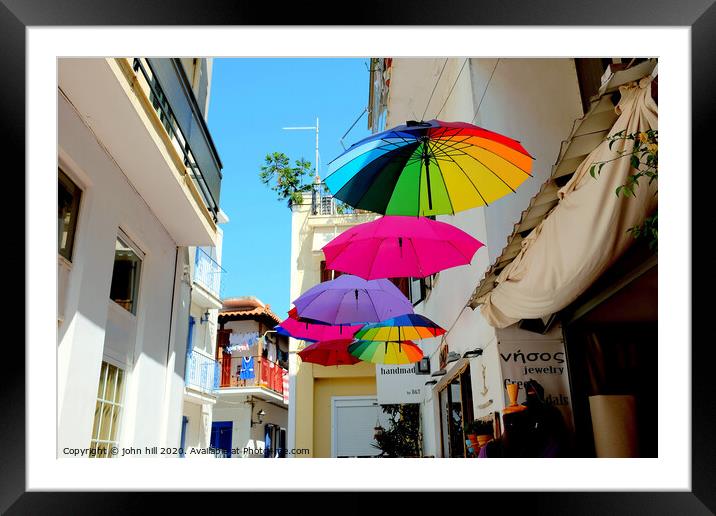 Colorful Parasols hanging in street at Skiathos Town in Greece.  Framed Mounted Print by john hill