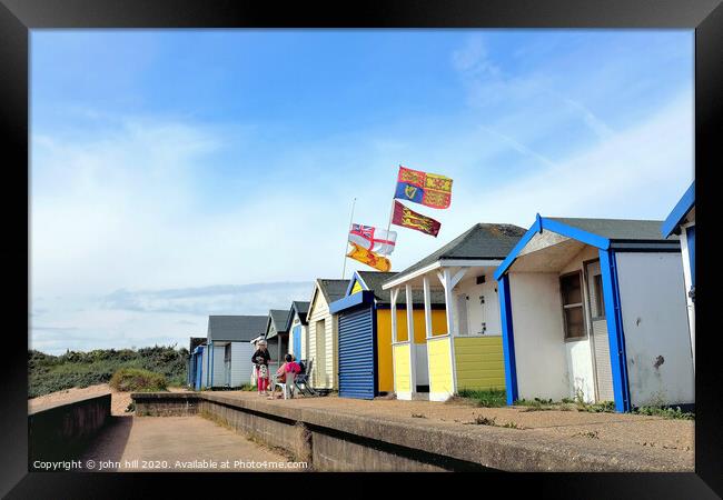 Beach hut flying the royal standard at Chapel point in Lincolnshire.  Framed Print by john hill