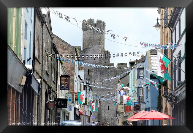 Flags and bunting at Caernarfon in Wales. Framed Print by john hill
