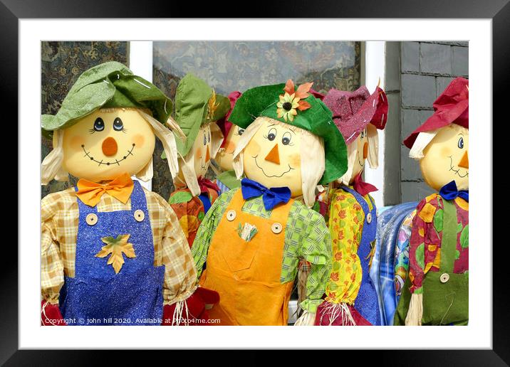 Homemade Scarecrows for sale outside a shop at Porthmadog in Wales.  Framed Mounted Print by john hill