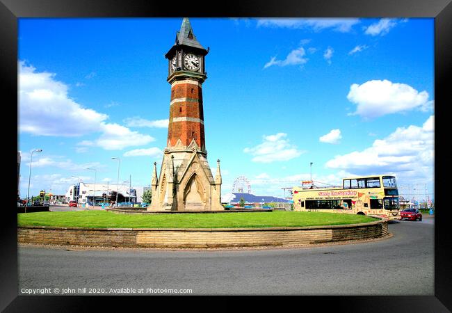 The landmark clock tower against a blue sky at Skegness in Lincolnshire. Framed Print by john hill