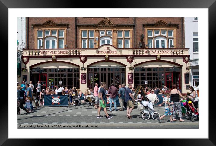 Summer visitors outside the old Borough Hotel public house on the seafront at Southend on Sea, Essex. Framed Mounted Print by Peter Bolton