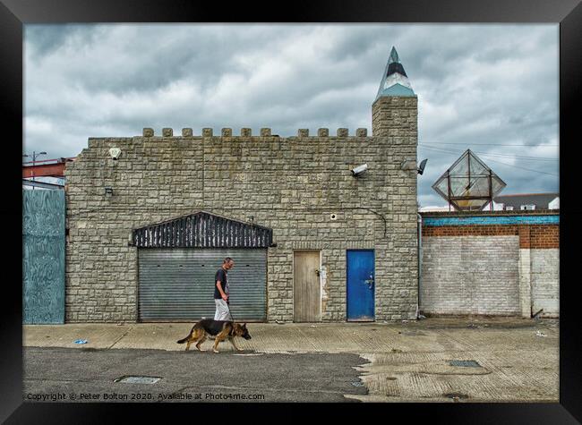 Man and dog walk in front of abandoned seaside arcade at Southend on Sea, Essex. Framed Print by Peter Bolton
