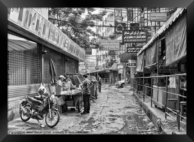 A side street in central Bangkok, Thailand, after heavy rain. Framed Print by Peter Bolton