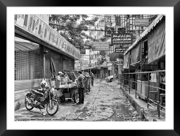 A side street in central Bangkok, Thailand, after heavy rain. Framed Mounted Print by Peter Bolton