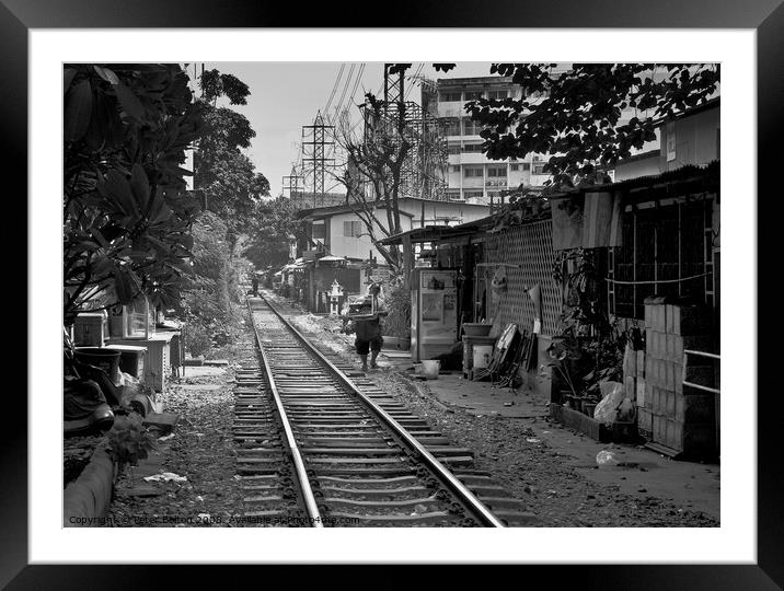 Railway track in central Bangkok, Thailand, with houses alongside. Framed Mounted Print by Peter Bolton