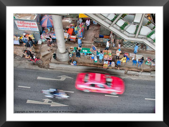 Overhead view of a street with food vendors and traffic speeding past. Bangkok, Thailand. Framed Mounted Print by Peter Bolton