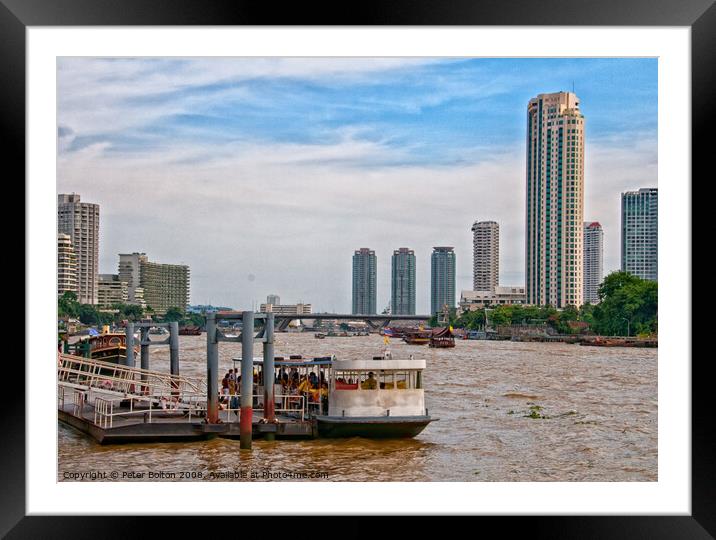 Ferry terminal with cityscape on the Chao Phraya River, Bangkok, Thailand. Framed Mounted Print by Peter Bolton