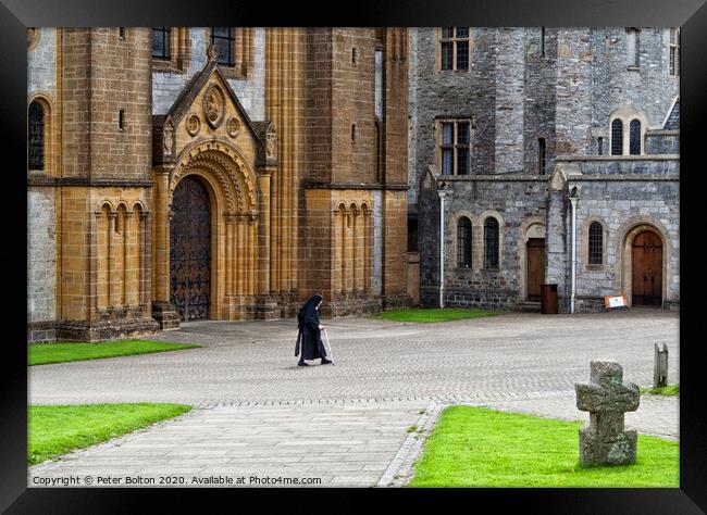 A nun crosses the courtyard at Buckfast Abbey, Dev Framed Print by Peter Bolton