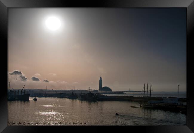 Early morning, leaving Casablanca, Morocco. Silhouette of the Grand Mosque as the sun burns through the mist. Framed Print by Peter Bolton