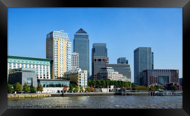 Canary Wharf business district viewed form the Thames on The Isle of Dogs, London, UK. Framed Print by Peter Bolton