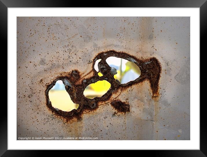Holes in a metal fence Framed Mounted Print by Kevin Plunkett