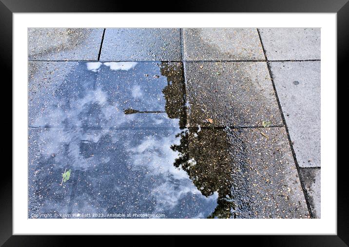 Sidewalk reflections from a rain  puddle Framed Mounted Print by Kevin Plunkett