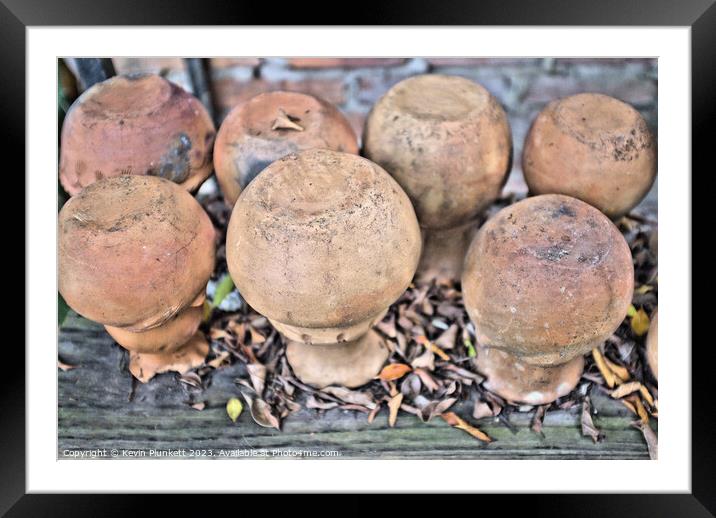 A close up of a pile of upside clay pots Framed Mounted Print by Kevin Plunkett