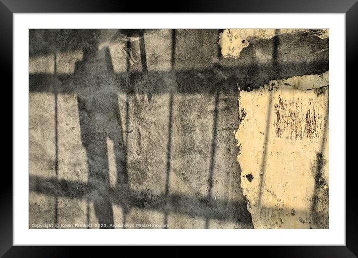 A close up of a street wall with shadows Framed Mounted Print by Kevin Plunkett