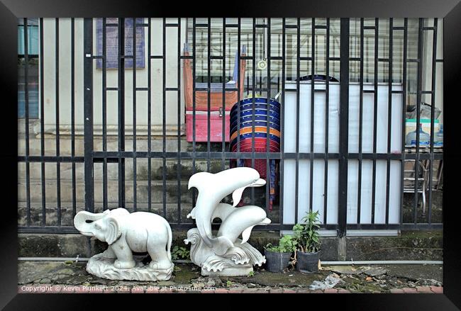 Elephant and Dolphins on a Ho Chi Minh City sidewalk. Framed Print by Kevin Plunkett