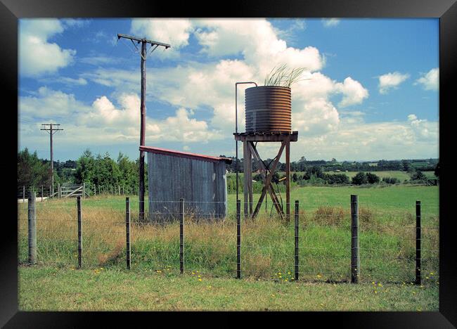 Unused water tank in the countryside in New Zealand Framed Print by Kevin Plunkett