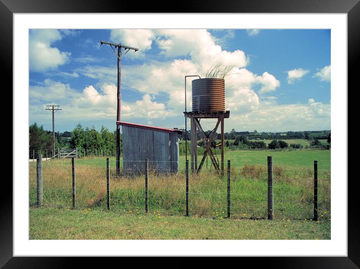 Unused water tank in the countryside in New Zealand Framed Mounted Print by Kevin Plunkett
