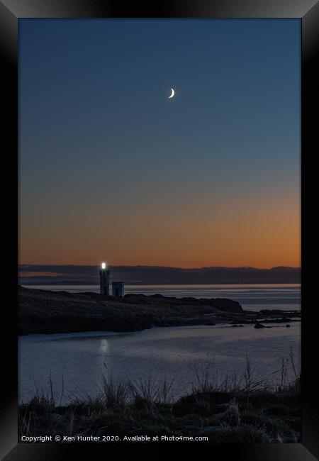 Lighthouse Beacon at Dusk on a Wintry Headland Framed Print by Ken Hunter