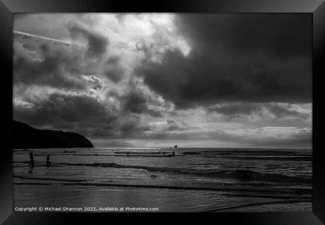Surfers in the sea at Perranporth in Cornwall Framed Print by Michael Shannon