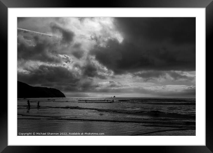 Surfers in the sea at Perranporth in Cornwall Framed Mounted Print by Michael Shannon