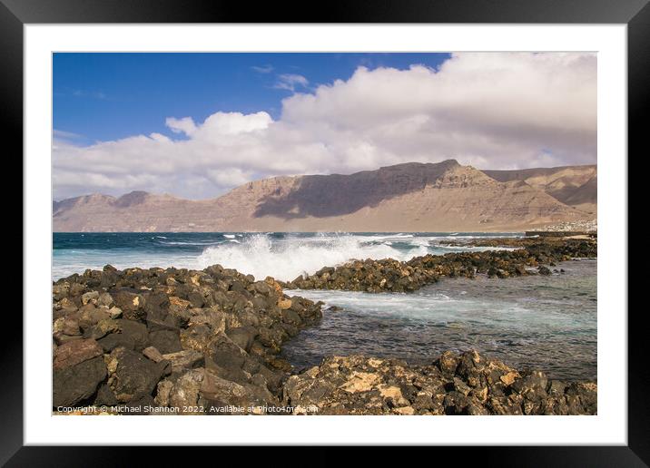Waves breaking against the rocks along the beach a Framed Mounted Print by Michael Shannon