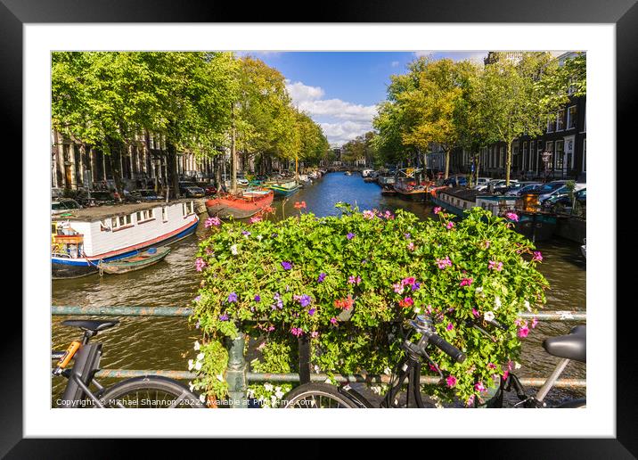 Bike, flowers on bridge over canal in Amsterdam Framed Mounted Print by Michael Shannon