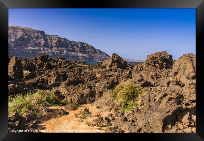 Beach path from Orzola which navigates a rocky tra Framed Print by Michael Shannon