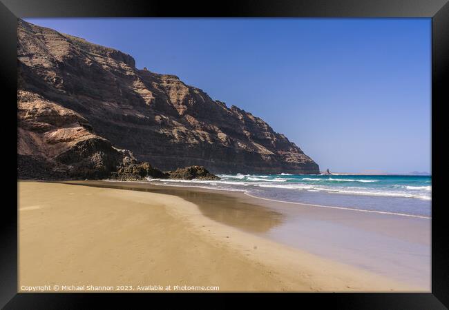The beach at Orzola near the cliffs of the Punta F Framed Print by Michael Shannon