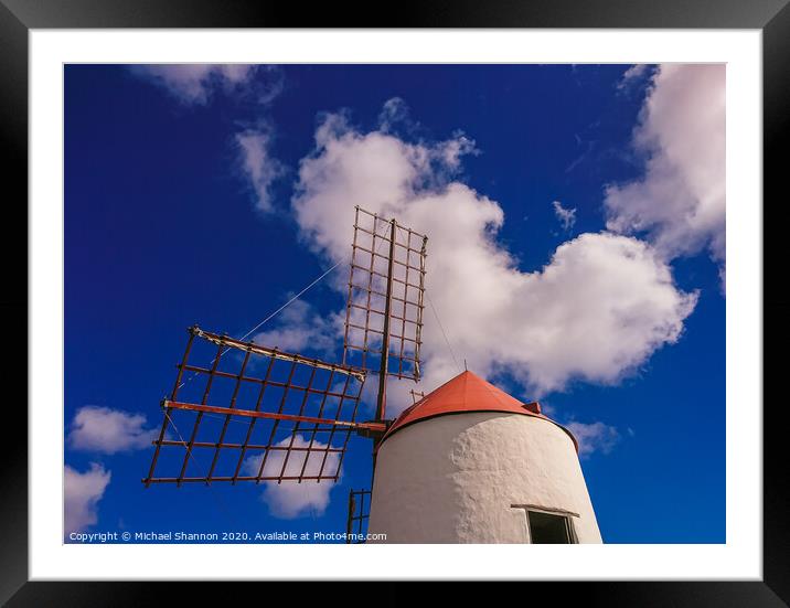 Windmill and sails on a sunny day in Lanzarote, Ca Framed Mounted Print by Michael Shannon