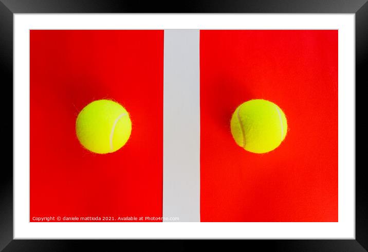 two tennis balls divided by a field line Framed Mounted Print by daniele mattioda