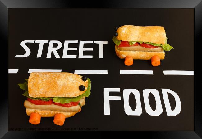 two sandwiches   shaped  car  represent the activity of street food Framed Print by daniele mattioda