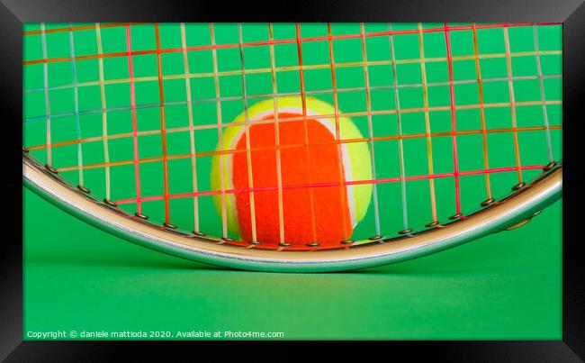 a racket and a tennis ball Framed Print by daniele mattioda