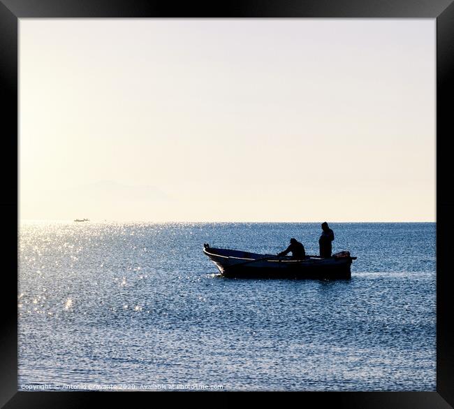 Fisherman boat in silhouette Framed Print by Antonio Gravante