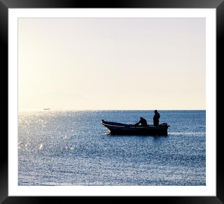 Fisherman boat in silhouette Framed Mounted Print by Antonio Gravante