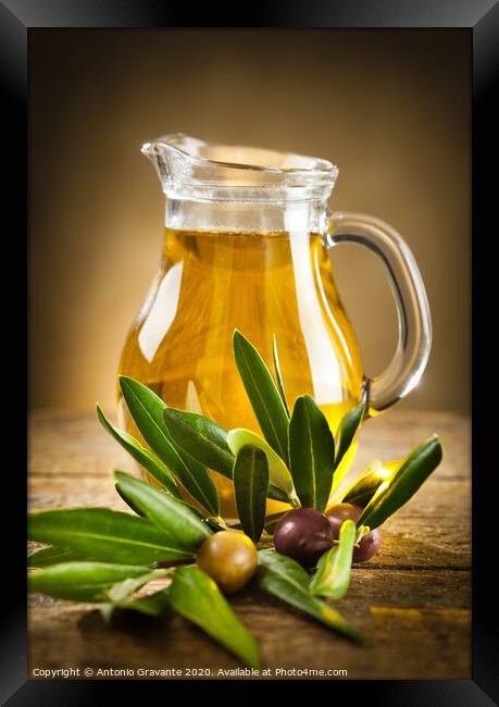 Bottle of olive oil and an olive branch Framed Print by Antonio Gravante