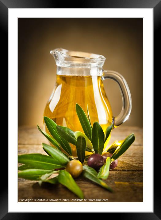 Bottle of olive oil and an olive branch Framed Mounted Print by Antonio Gravante