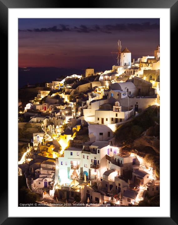 Oia village by night in Santorini island Framed Mounted Print by Antonio Gravante