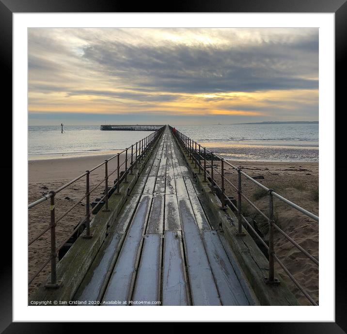 A pier heading out to sea Framed Mounted Print by Iain Cridland