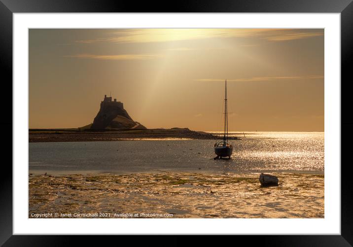 Sunrays on Lindisfarne Harbour and Castle Framed Mounted Print by Janet Carmichael