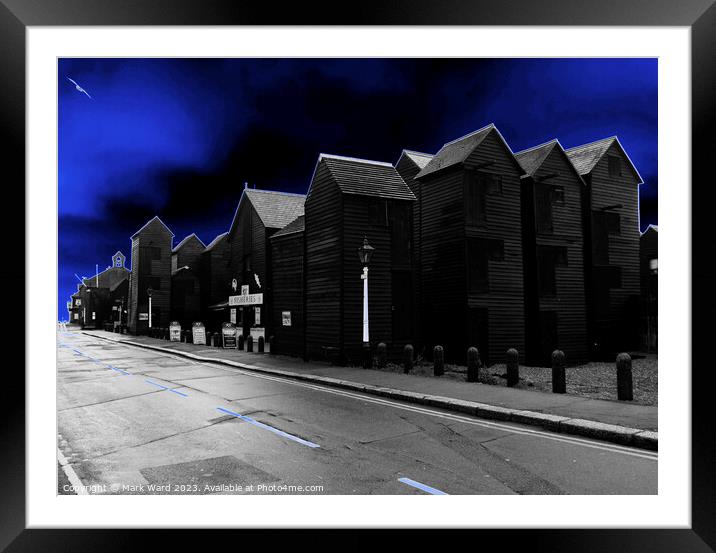 Glowing Hastings Net Huts. Framed Mounted Print by Mark Ward