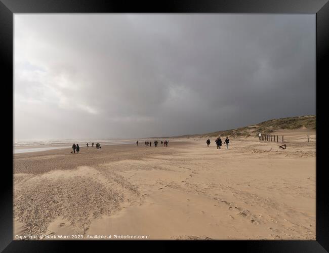 Winter Walkers at Camber Sands. Framed Print by Mark Ward