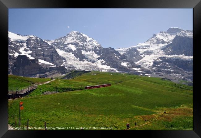 Famous electric red tourist train with mountains in the background Framed Print by PhotOvation-Akshay Thaker