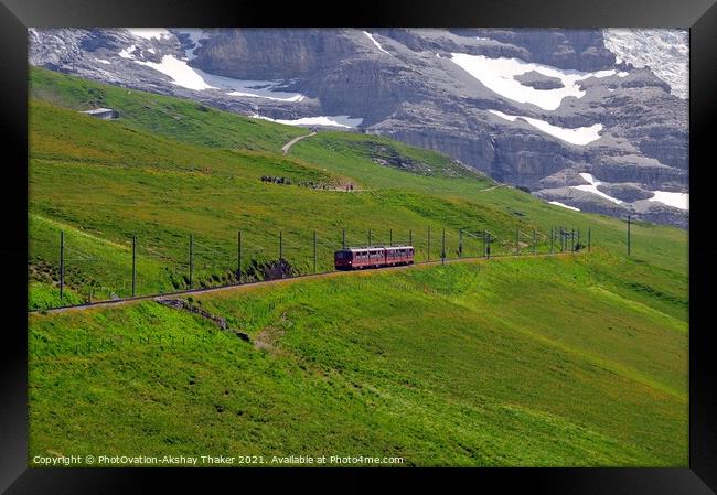The famous tourist train grazing on a lush green hillside Framed Print by PhotOvation-Akshay Thaker