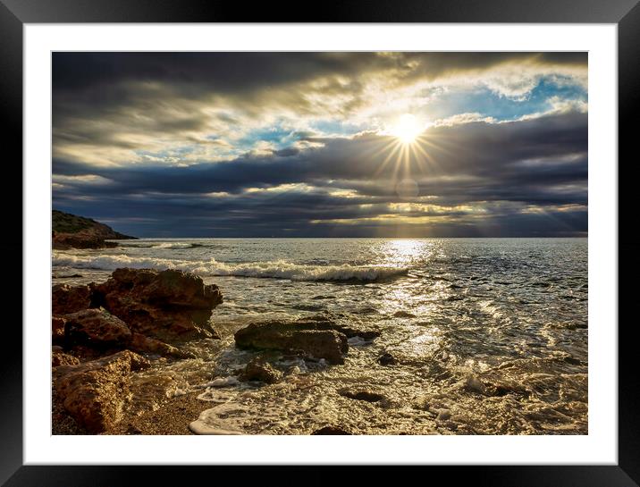 The sunrise sun through the clouds from a small cove Framed Mounted Print by Vicen Photo