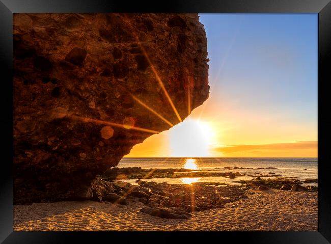 Photography with the sunrise sun behind the rock of the beach of the dead Framed Print by Vicen Photo