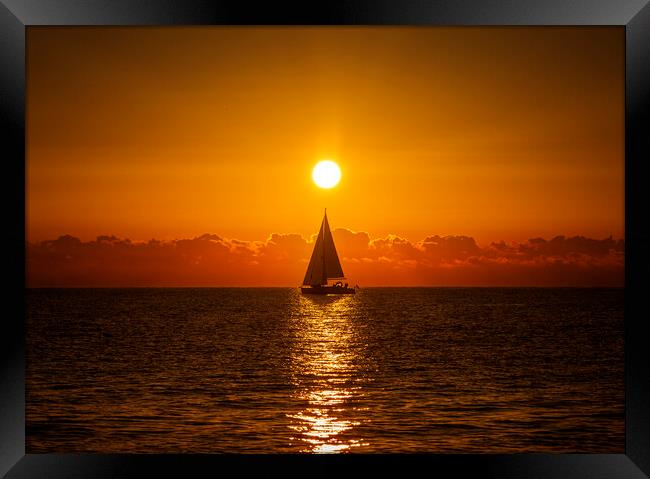 A lone sailboat sailing in the dawn sun Framed Print by Vicen Photo