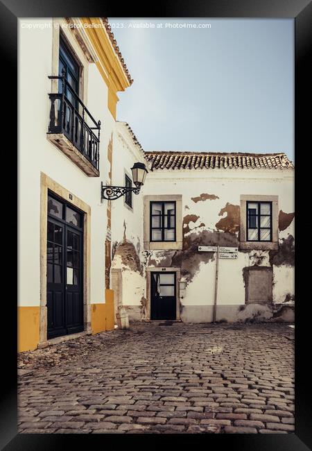View on one of the cozy cobblestoned alleys of the old town Faro in Portugal Framed Print by Kristof Bellens