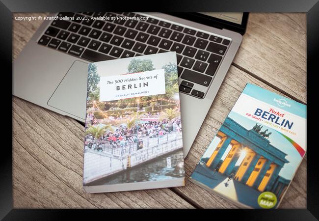 Planning a trip to Berlin with laptop on wooden table and travel guides Framed Print by Kristof Bellens