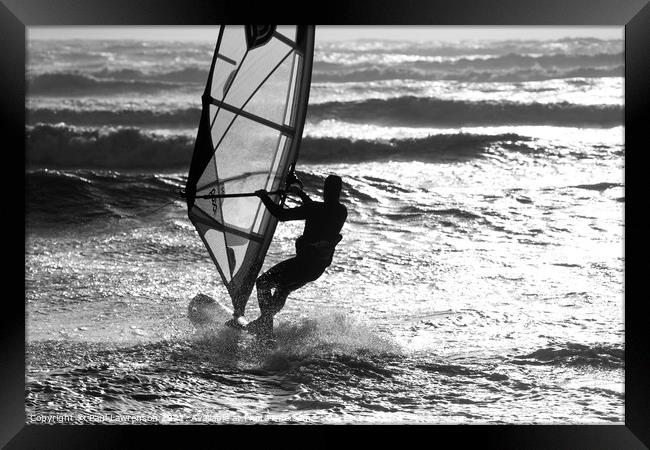 Wind surfer heads out to sea Framed Print by Paul Lawrenson